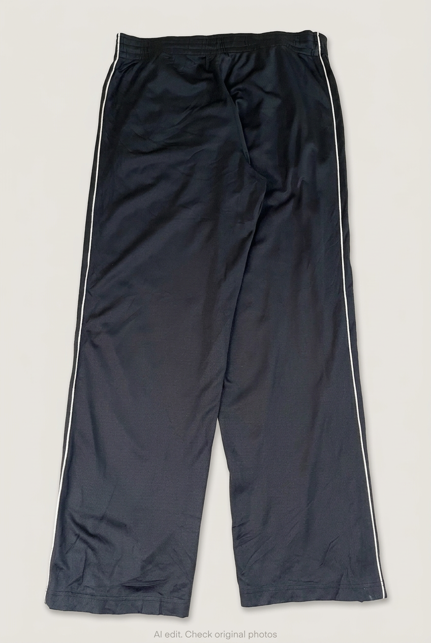 Back product view of black Reebok track pants, flat lay