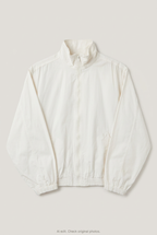 Front product view of cream windbreaker, flat lay