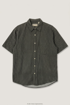 Front product view of dark printed short-sleeve shirt, flat lay